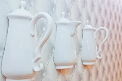 three white vases are sitting on a wall at Hotel La Villa Nice Victor Hugo in Nice