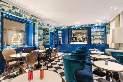 a restaurant with tables and chairs and a bar at Villa Otero by Happyculture in Nice