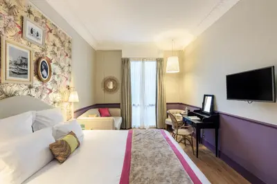 a hotel room with a bed and a desk at Villa Otero by Happyculture in Nice