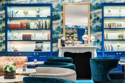 a room with blue walls and chairs and a fireplace at Villa Otero by Happyculture in Nice