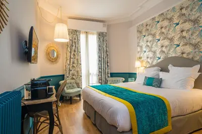 a hotel room with a bed and a desk and a bedroom at Villa Otero by Happyculture in Nice