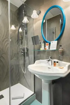 a bathroom with a sink and a mirror at Villa Bougainville by Happyculture in Nice