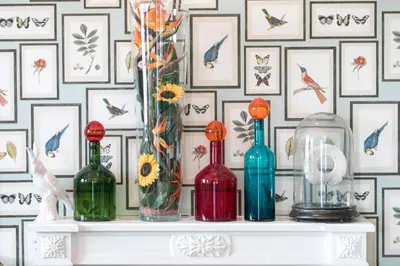 four bottles on a shelf in front of a wall at Villa Bougainville by Happyculture in Nice