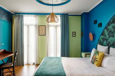a bedroom with blue and green walls and a bed at Villa Bougainville by Happyculture in Nice