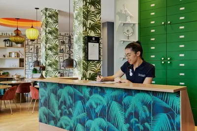 a woman sitting at a counter in a restaurant at Villa Bougainville by Happyculture in Nice
