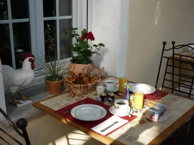 a table with a chicken and plates on it at Logis Hôtel Villa Victorine in Nice