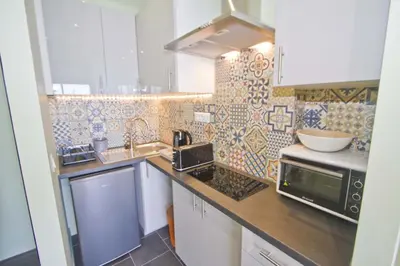 a kitchen with a sink and a microwave at PROMENADE HOLIDAY - SUFFREN BEACH in Nice