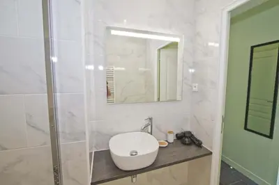 a white bathroom with a sink and a mirror at PROMENADE HOLIDAY - SUFFREN BEACH in Nice