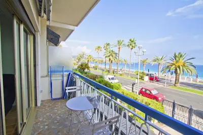 a balcony with a table and a view of the ocean at PROMENADE HOLIDAY - SUFFREN BEACH in Nice