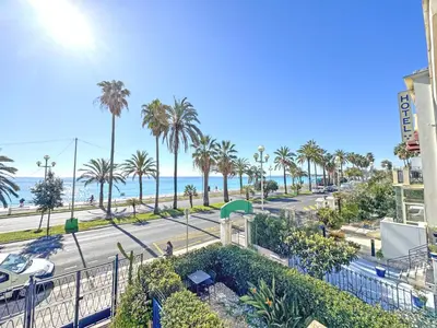 a view of a street with palm trees and the ocean at PROMENADE HOLIDAY - SUFFREN BEACH in Nice