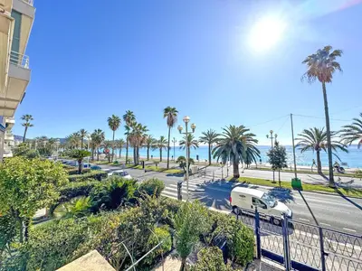 a view of a street with palm trees and the ocean at PROMENADE HOLIDAY - SUFFREN BEACH in Nice
