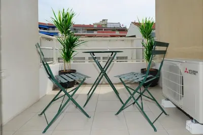two chairs and a table with plants on a balcony at Mini suite Othello - Five Stars Holiday House in Nice