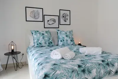 a bedroom with a bed with towels on it at Mini suite Othello - Five Stars Holiday House in Nice