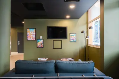 a living room with two blue couches and a tv at easyHotel Nice Old Town in Nice