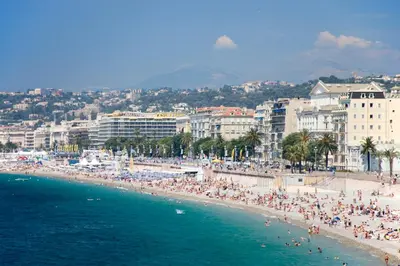 a group of people on a beach with the ocean at easyHotel Nice Old Town in Nice