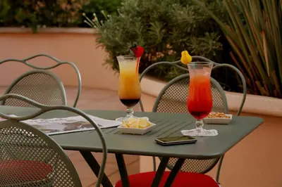 a green table with two drinks on it at easyHotel Nice Old Town in Nice