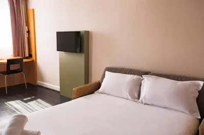 a bedroom with a bed and a tv on the wall at easyHotel Nice Old Town in Nice