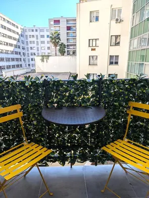 two chairs and a table in front of a plant at H33 Hôtel in Nice