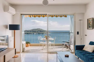 a living room with a view of the ocean at French Riviera - 3 pièces, vue mer et piscine in Villefranche-sur-Mer