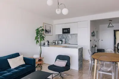 a living room with a couch and a table at French Riviera - 3 pièces, vue mer et piscine in Villefranche-sur-Mer
