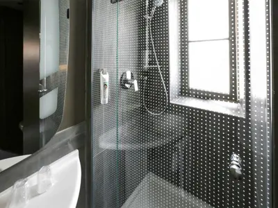 a bathroom with a shower with a glass door at ibis Nice Centre Notre Dame in Nice