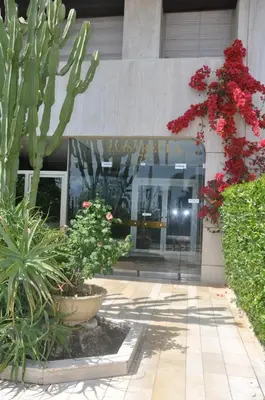 a building with flowers and plants in front of it at STUDIO PROMENADE FLORIDA BEACH in Nice
