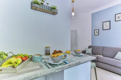 a kitchen with a table with fruit on it at MY CASA - GROSSO 14 - 5 min walk to beach in Nice