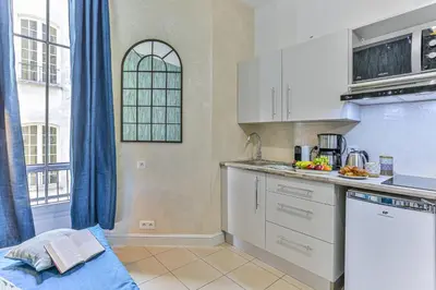 a kitchen with white cabinets and a counter top at MY CASA - GROSSO 14 - 5 min walk to beach in Nice