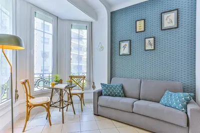 a living room with a couch and a table at MY CASA - GROSSO 14 - 5 min walk to beach in Nice