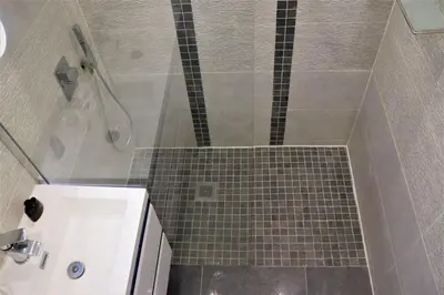a bathroom with a shower with a tiled floor at 2P NEUF vue Promenade des Anglais / Tram 10min centre in Nice