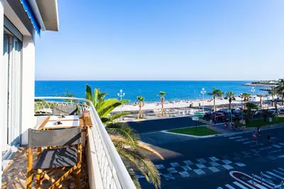 a balcony with a view of the beach and the ocean at #23 Henry IV Vue Panoramique Mer AC & Bright in Nice