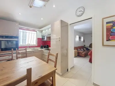 a kitchen and dining room with a table and a clock at Nestor&Jeeves - MAISON COURNICHEE - Central - Close sea - Atypical in Nice