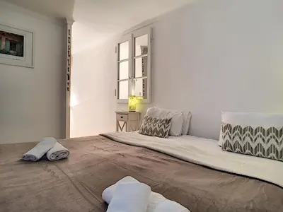 a bedroom with a large bed with two pillows at Nestor&Jeeves - MAISON COURNICHEE - Central - Close sea - Atypical in Nice
