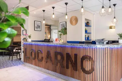 a bar with a sign that says loam at Hôtel Locarno Nice in Nice