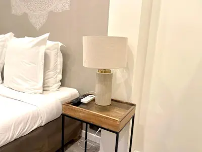 a lamp on a table next to a bed at Villa Berlioz in Nice