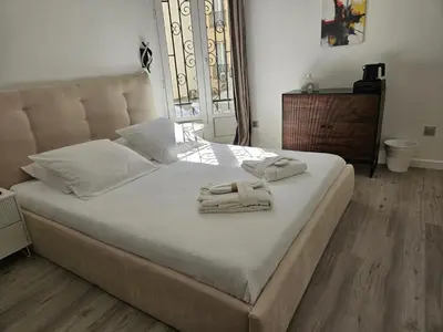 a bedroom with a bed with two towels on it at Villa Berlioz in Nice
