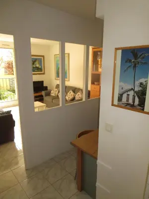 a living room with a room with a couch and windows at Vieux Nice, grand 2P sur jardins, parking, calme, soleil in Nice