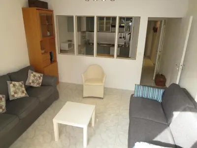 a living room with a couch and a table at Vieux Nice, grand 2P sur jardins, parking, calme, soleil in Nice