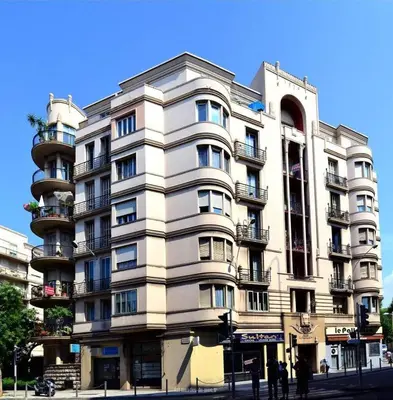 a tall building with people standing outside of it at Nice Centre Studio Proche Mer in Nice