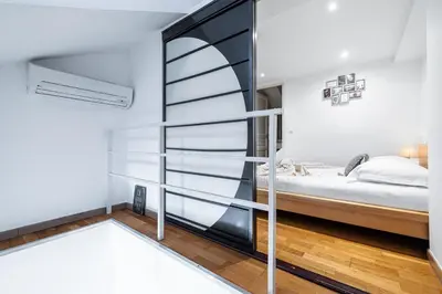 a room with a bed and a glass wall at Massena Street - 1 Bdr Duplex with AC & Parking in Nice