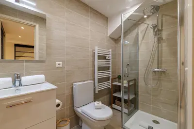 a bathroom with a toilet and a shower and a sink at Massena Street - 1 Bdr Duplex with AC & Parking in Nice