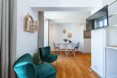 a living room and dining room with a table and chairs at Massena Street - 1 Bdr Duplex with AC & Parking in Nice