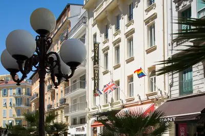 a street light in front of a building with flags at Hotel Le Meurice in Nice