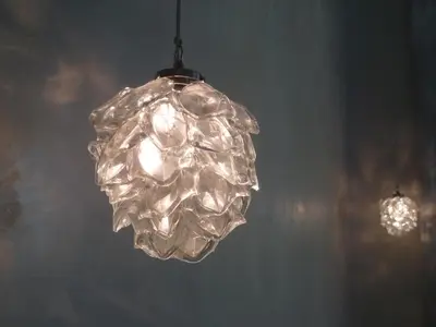 a clear glass chandelier hanging from a ceiling at Hotel Rossetti in Nice