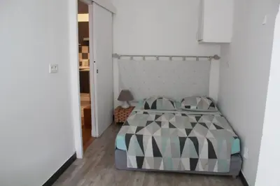 a bedroom with a bed with a headboard at T2 entièrement équipé, proche toutes commodités in Nice