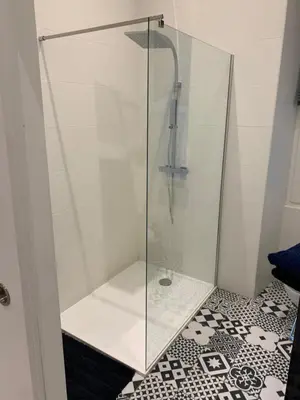 a shower with a glass door in a bathroom at Gustave in Nice