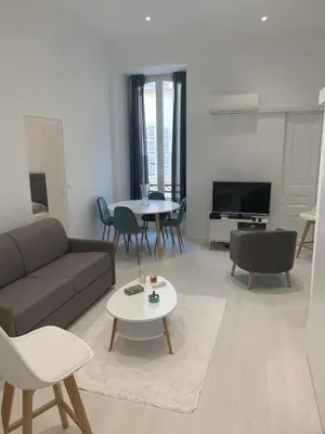 a living room with a couch and a table at Gustave in Nice