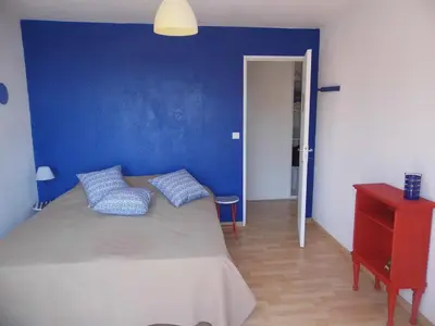a blue bedroom with a bed with two pillows at La Madonette in Nice