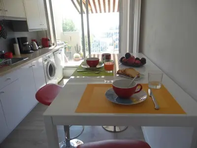a kitchen with a table with a cup of coffee on it at La Madonette in Nice