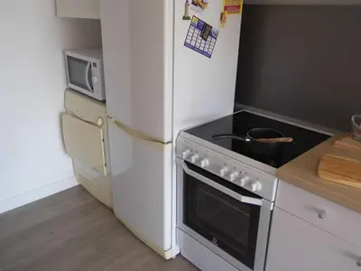 a kitchen with a white stove and a refrigerator at La Madonette in Nice